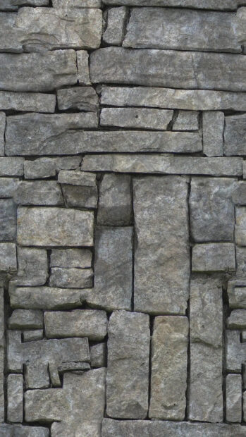 Close up view of rough stone texture with various shapes and sizes arranged tightly