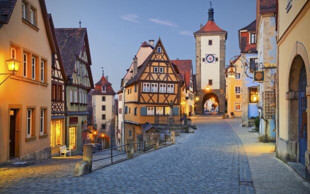 Old town street with historic buildings and cobblestone road in twilight