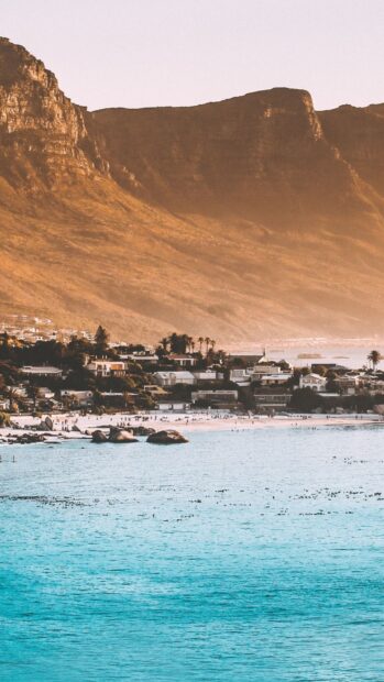 A scenic town with beach and mountains at sunset showcasing a coastal town landscape