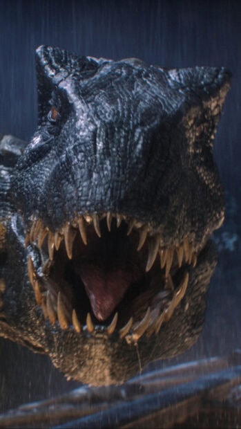 Close up of a Tyrannosaurus Rex roaring in the rain with sharp teeth visible