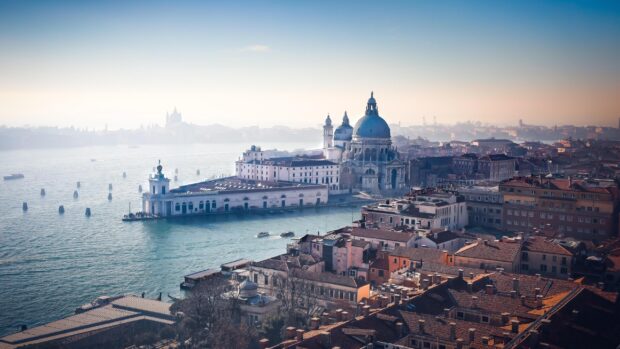 A scenic view of Venice showcasing historic buildings and waterways in a clear daytime setting
