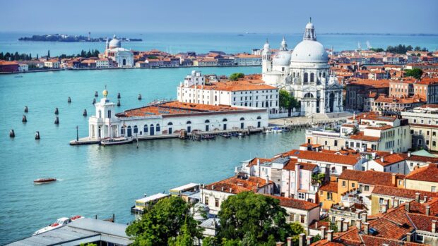 A stunning aerial view of Venice showcasing historic buildings and waterways in vibrant colors