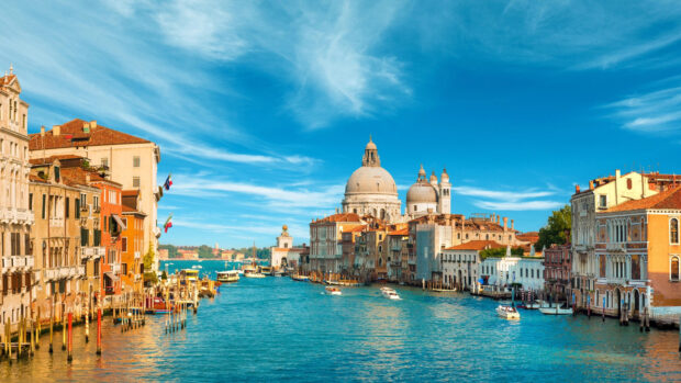 Beautiful Venice cityscape with historical buildings and clear blue canal water
