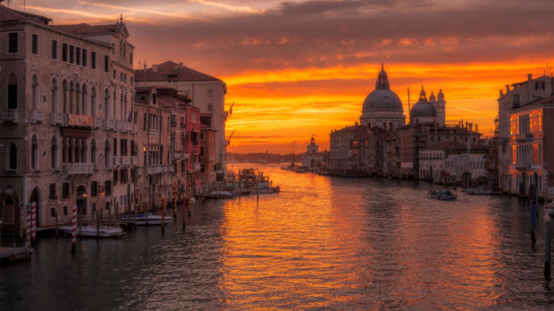 Stunning Venice cityscape with sunset reflecting on the water of the canal