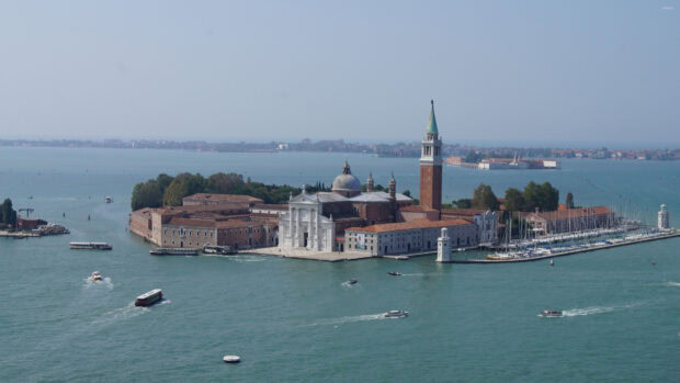 Aerial view of Venice island with historic buildings and boats on the water