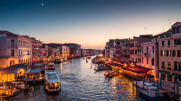 Evening view of Venice canal with historic buildings and boats