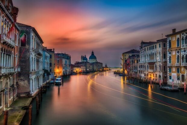 Venice canal with colorful historic buildings during sunset in Venice
