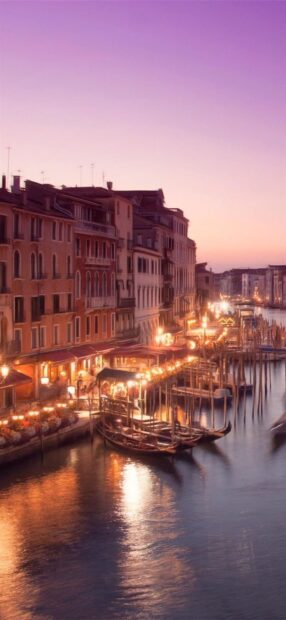 Evening view of Venice canal with gondolas and historic buildings