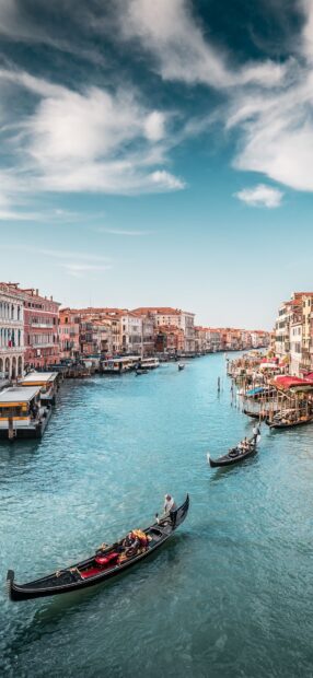 Gondola rides on the Venice canal with historic buildings in the background