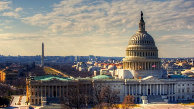 The United States Capitol building in Washington Dc under a partly cloudy sky
