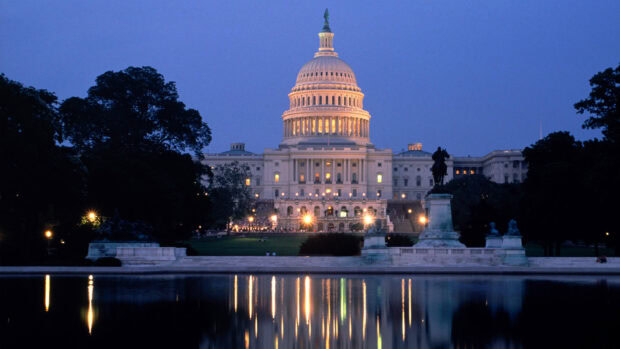The United States Capitol at dusk in Washington Dc with reflections in the water