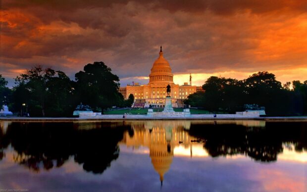 The Washington Dc Capitol building with its reflection during a dramatic sunset sky