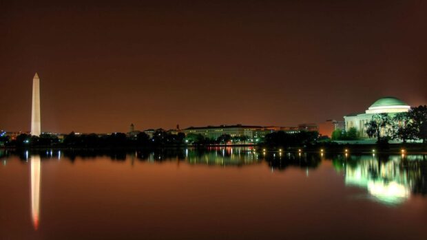 Washington Dc cityscape at night with the Washington Monument and memorial reflections