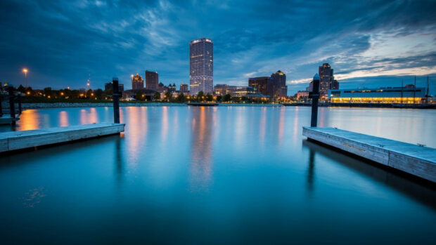 Evening cityscape with Milwaukee skyline reflecting on calm lake waters in Wisconsin