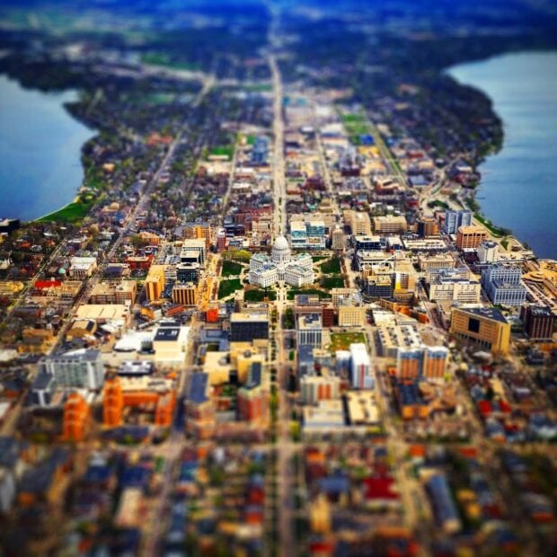 Aerial view of Wisconsin cityscape featuring the state capitol building and urban areas