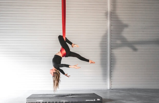 Aerial silks performance showing flexibility and strength in a studio setting