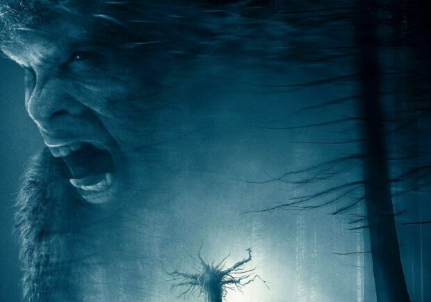 Bigfoot creature roaring fiercely in a dark foggy forest at night