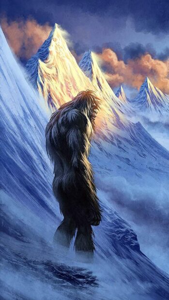 Bigfoot standing alone on a snowy mountain slope with glowing peaks in the background