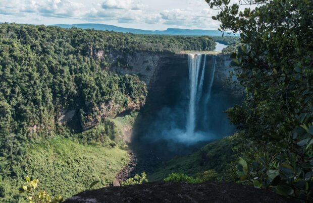 Lush Canaima National Park with towering waterfall and dense forest landscape