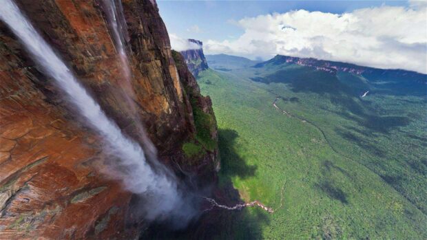 Stunning Canaima cliff with waterfall and vast forest valley in Canaima National Park
