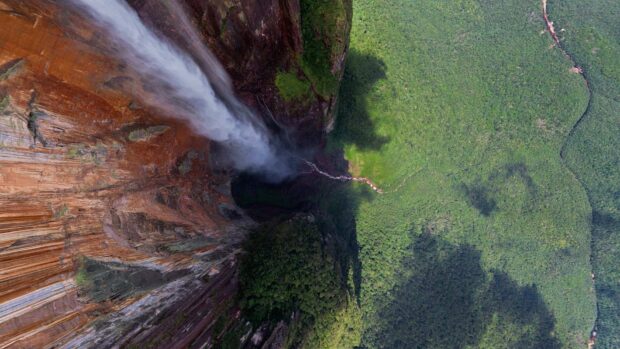 Aerial view of Canaima National Park waterfall surrounded by dense forest