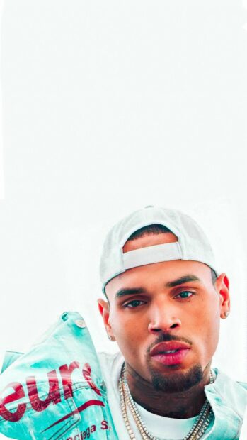 Chris Brown wearing a cap and jacket with chains around his neck
