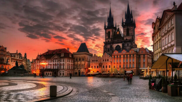 Historic city square featuring classic architecture under a vibrant sunset sky