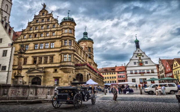 Historic city square with classic architecture and vintage car in HD quality