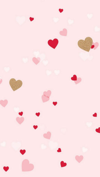 Pink background with scattered red and gold hearts in cute Valentine design