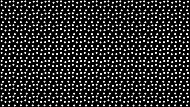 White dots pattern arranged in a star like shape on a black surface