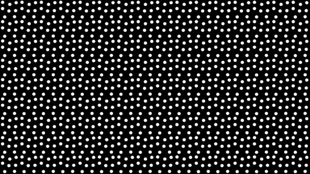 White dots pattern evenly distributed on a black surface with a textured effect
