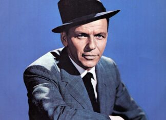 Frank Sinatra wearing a hat and suit posing against a blue background