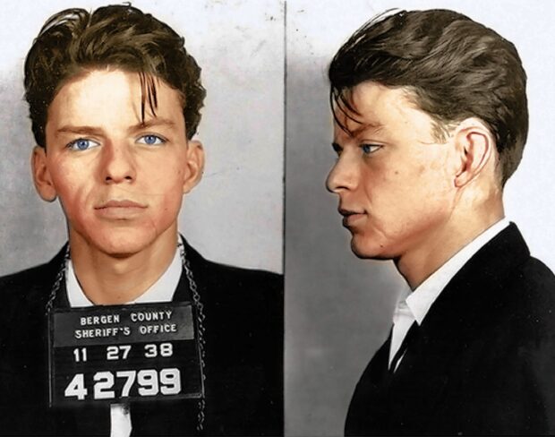 Young Frank Sinatra mugshot in black suit with blue eyes and vintage style