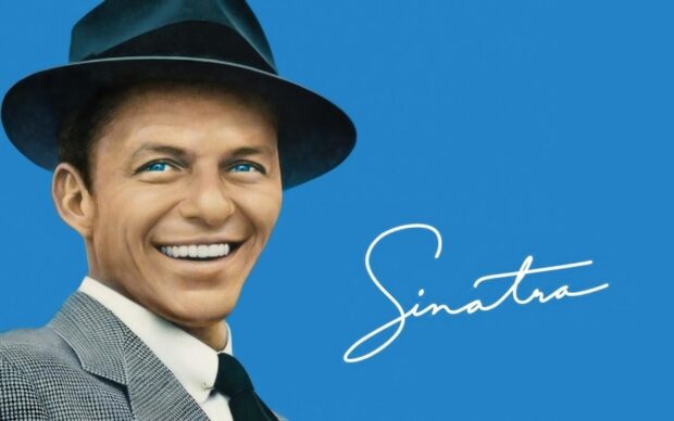 A smiling man wearing a hat and suit representing Frank Sinatra on a blue background