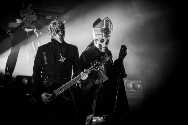 The Ghost Band performing live on stage with elaborate costumes and masks