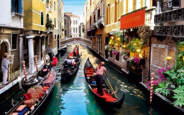 Gondola boats carrying tourists through Venetian canals in a vibrant cityscape