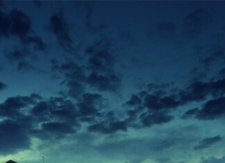 Evening gondola ride with passengers on calm water in Venice canal