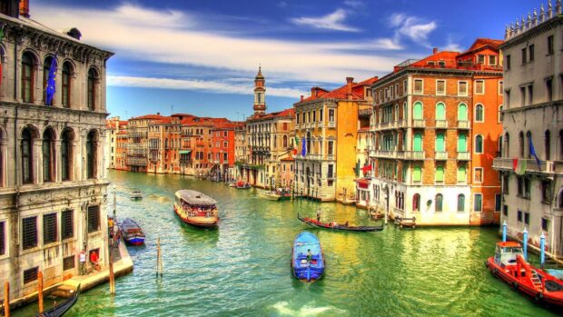 A vibrant Venice canal scene with gondola and boats passing colorful historic buildings