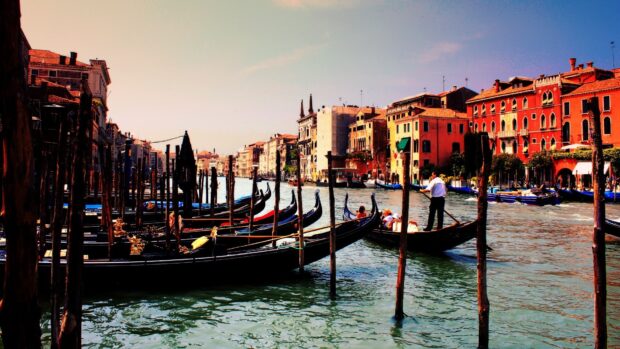 Gondolas floating on the canal in Venice with historic buildings lining the waterway