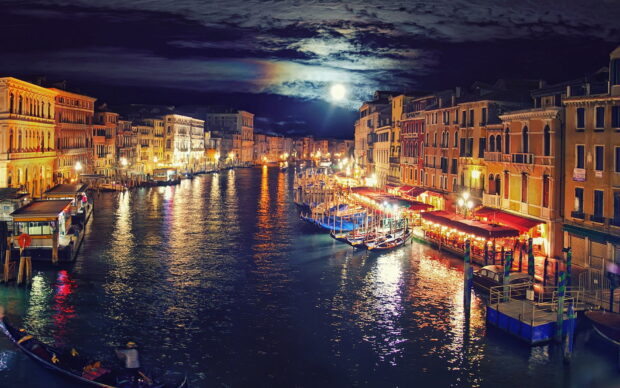 A peaceful gondola floating on the water under the moonlight in Venice