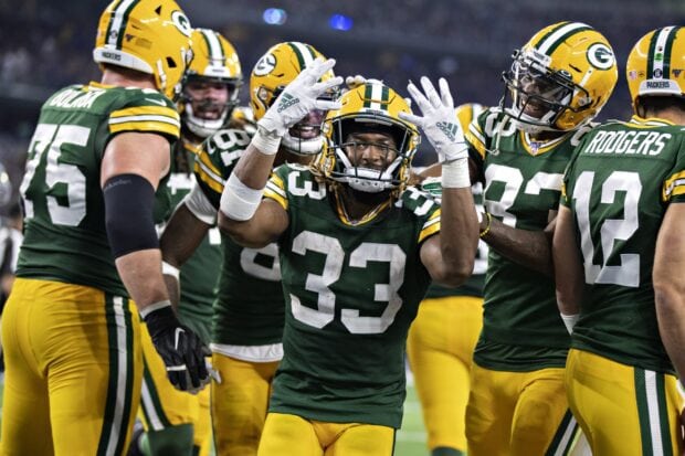 Green Bay Packers player celebrating with teammates on the field