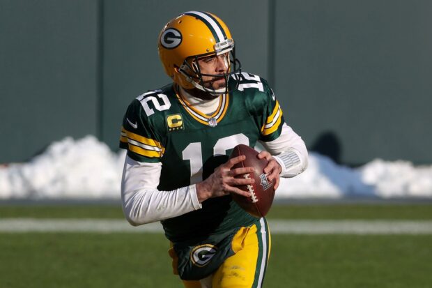 Green Bay Packers player preparing to throw a football during a game