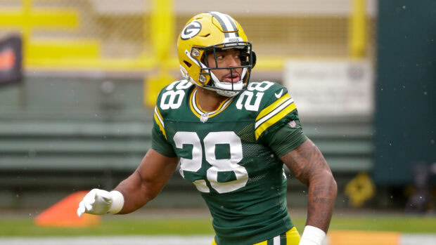 Green Bay Packers player wearing number 28 jersey preparing for the play on the field