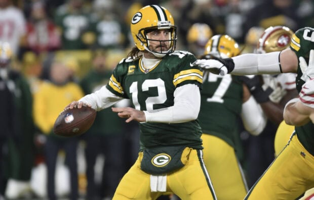Green Bay Packers player preparing to throw the ball during a football game