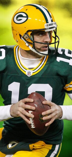 Green Bay Packers player preparing to throw a football during a game