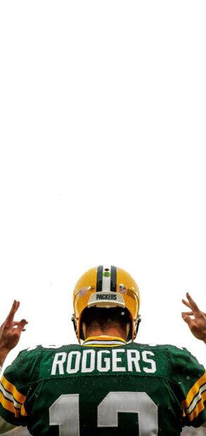 Football player Rodgers wearing Green Bay Packers jersey and helmet viewed from behind on a rainy day