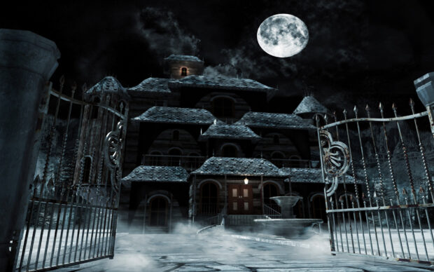 Haunted house with fog and full moon under dark sky at night
