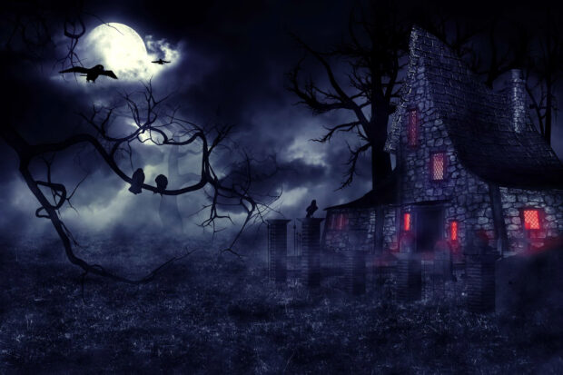 A haunted house surrounded by dark trees under a full moon with eerie glowing windows