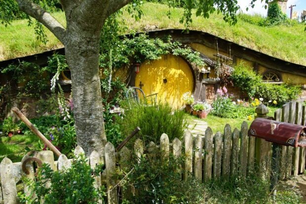 A charming hobbit house surrounded by a lush garden in Hobbiton