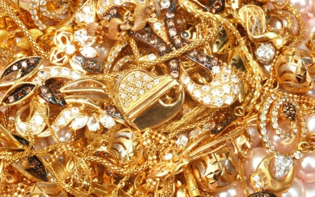 A close up view of jewels featuring gold and gem designs sparkling with intricate details